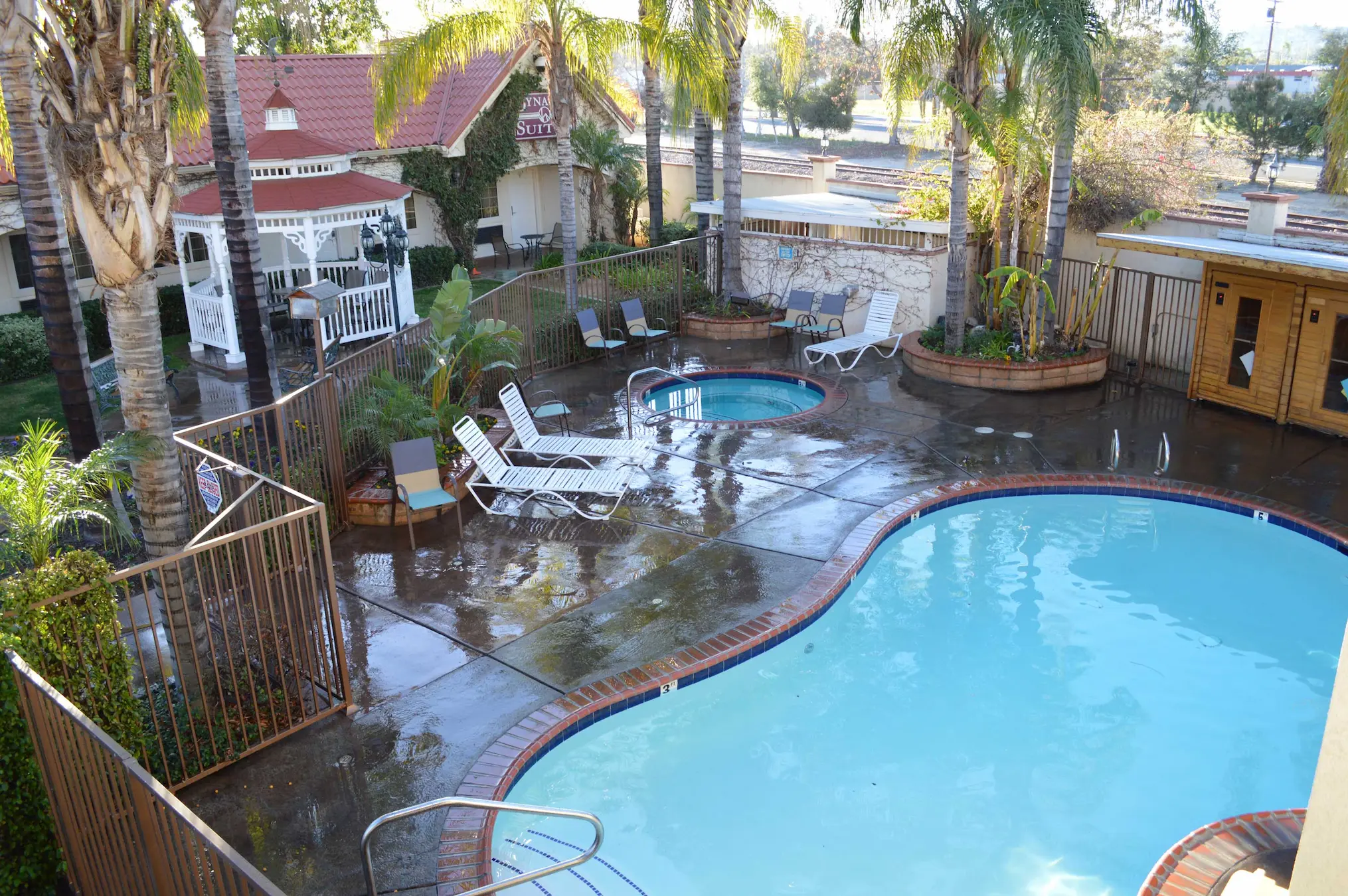 Outdoor pool and spa area at Dynasty Suites Redlands