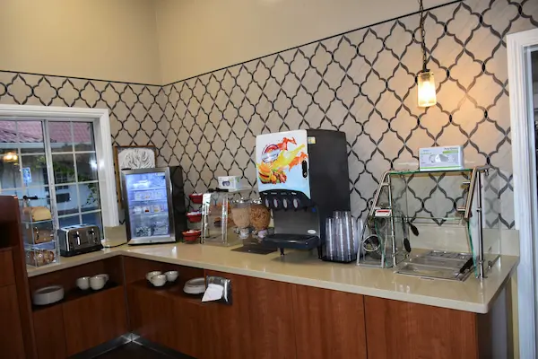 Photo of Breakfast buffet left side with hot food, juices and breds