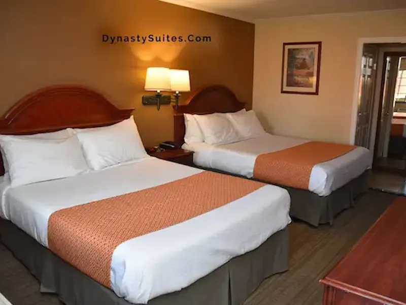 Deluxe Two Queen guest room with two beds and in-room furnishings.