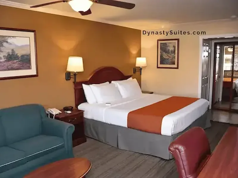 Deluxe King guest room with a king bed, seating area and warm lighting.