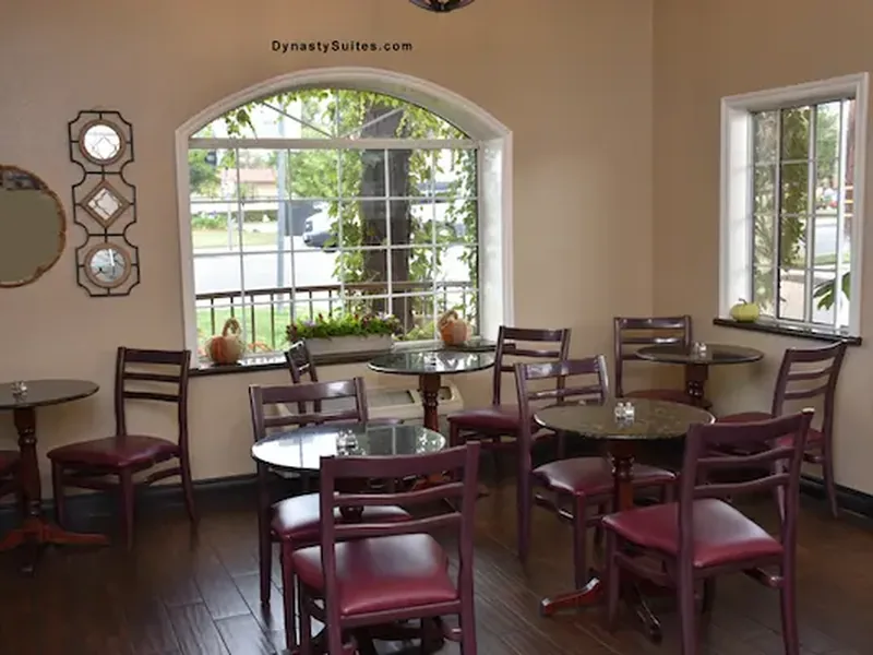 Hotel breakfast dining room with tables and seating.